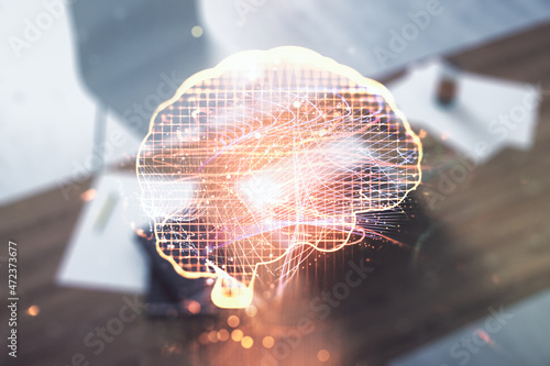 Creative artificial Intelligence concept with human brain hologram and modern desktop with computer on background. Multiexposure