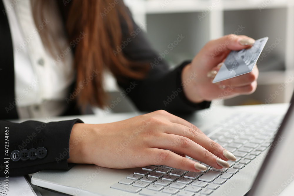 Woman press knobs on keyboard, pay online with credit card, remote shopping on laptop Woman press knobs on keyboard, pay online with credit card, remote shopping on laptop