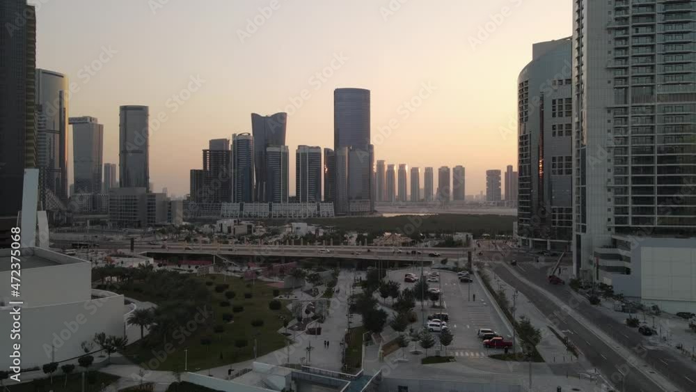 Sunset in Abu Dhabi, aerial view on Al Reem island modern skyscrapers between the mangroves in the sea Sunset in Abu Dhabi, aerial view on Al Reem island modern skyscrapers between the mangroves in the sea