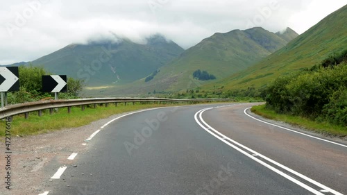 A87 road in Isle of Skye, Scotland with mountains and low clouds