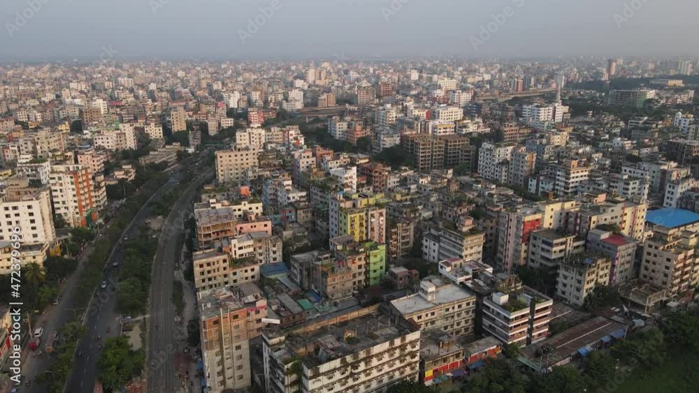 Aerial View Over Dense Metropolitan Cityscape Condominiums With Highway Running Past. Dolly Forward Aerial View Over Dense Metropolitan Cityscape Condominiums With Highway Running Past. Dolly Forward