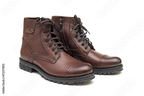 Men boots made of genuine leather on a white background © Vastram