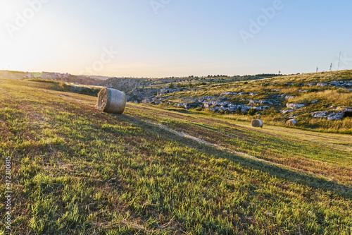 Summer landscape in Matera wheat fields, south Italy. Sunset in the sky.