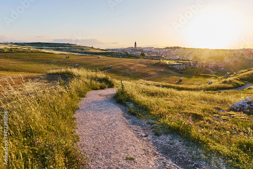 Summer landscape in Matera wheat fields, south Italy. Sunset in the sky.