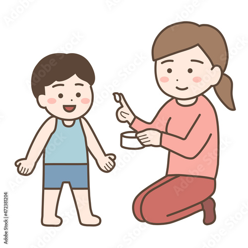 子どもに塗り薬を塗るお母さん