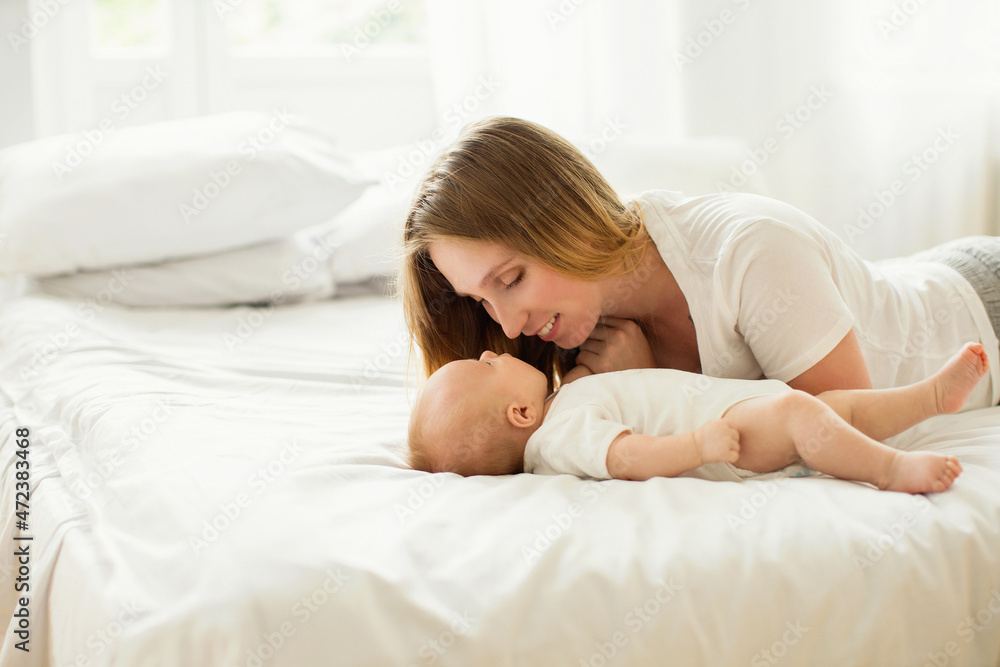 Happy young mother with her newborn baby at home. Happy young mother with her newborn baby at home.