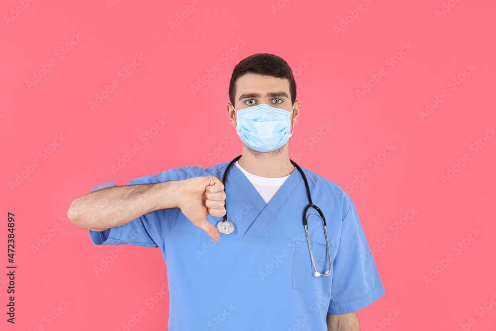 Young attractive male nurse on pink background Young attractive male nurse on pink background