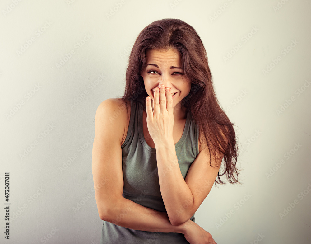 Happy sporty laughing beautiful woman with wide open mouth on vintage toned background and happy looking in green t-shirt. Portrait with empty copy space. Happy sporty laughing beautiful woman with wide open mouth on vintage toned background and happy looking in green t-shirt. Portrait with empty copy space.