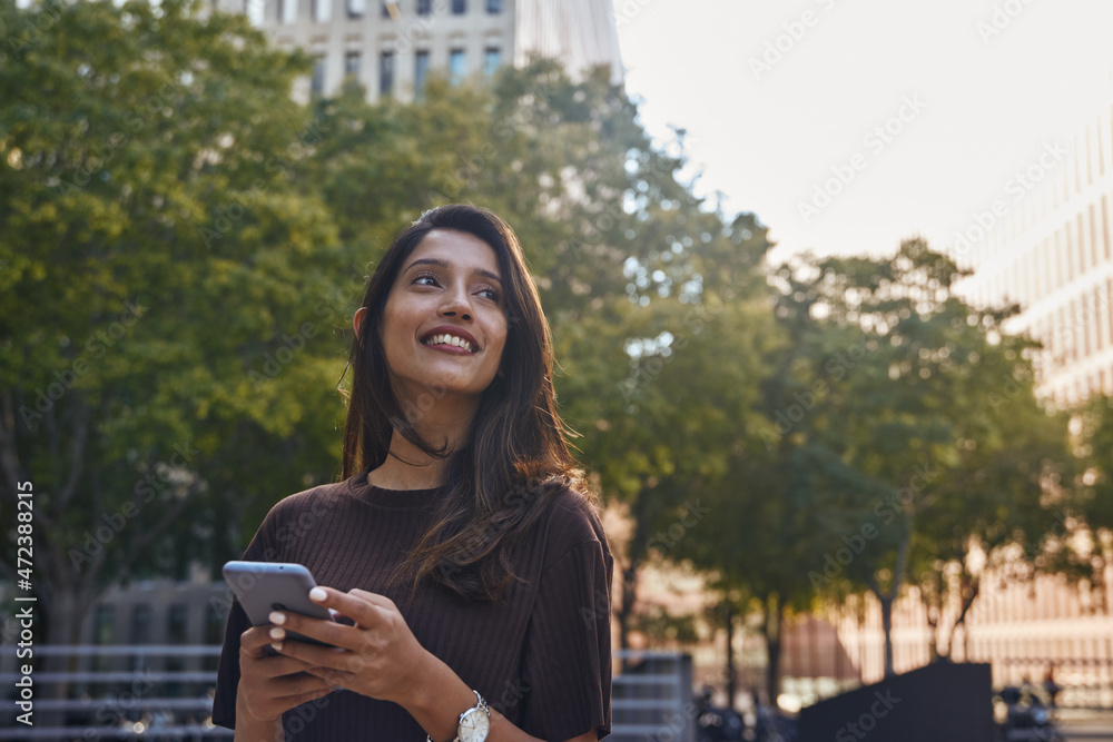 Fototapeta premium Smiling businesswoman looking away on street