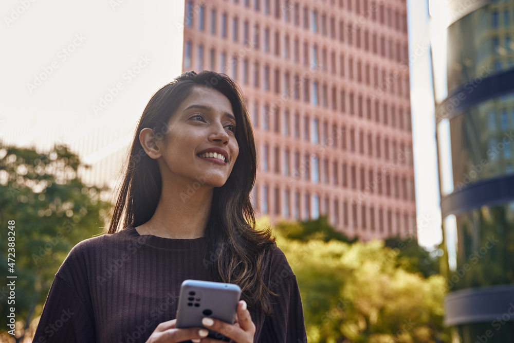 Young smiling businesswoman looking away happily Young smiling businesswoman looking away happily