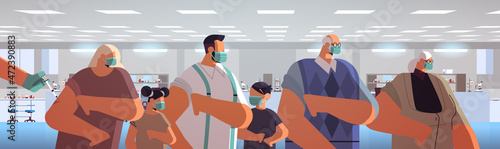 doctor hand vaccinating multi generation family patients in medical mask fight against coronavirus vaccine development