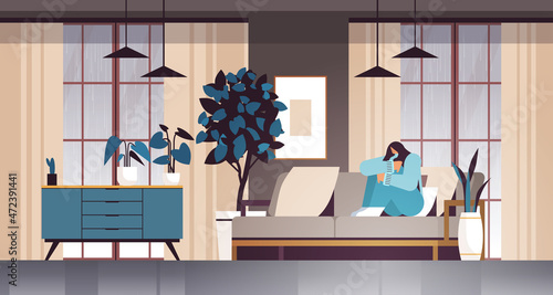 unhappy depressed woman sitting on sofa girl feeling desperate and lonely mental health diseases depression stress