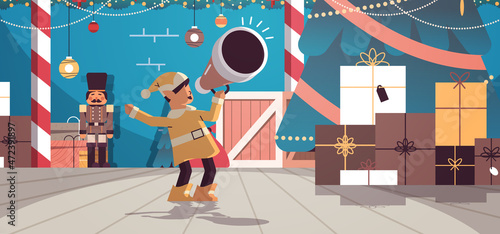 elf shouting in megaphone santa helper making announcement new year and christmas holidays celebration
