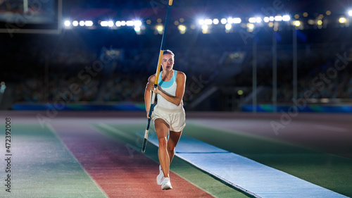 Pole Vault Jumping: Portrait of Professional Female Athlete on World Championship Running with Pole to Jump over Bar. Shot of Competition on Big Stadium with Sports Achievement Experience