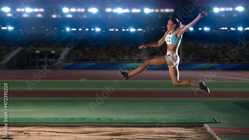 Foto Long Jump Championship: Professional Female Athlete Jumping on Long Distance