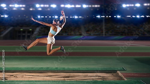 Long Jump Championship: Professional Female Athlete Jumping on Long Distance. Determination, Motivation, Inspiration of a Successful Sports Woman Setting New Record Result. Competition on Big Stadium. photo