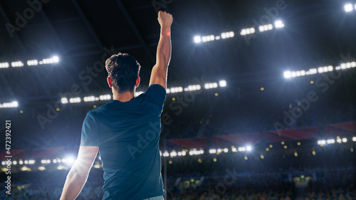 Portrait of Professional Male Athlete Happily Celebrating New Record for Winning Sport Championship. Determined Successful Sportsman Raising Arms Cheering for Gold Medal Victory. Shot on Large Stadium