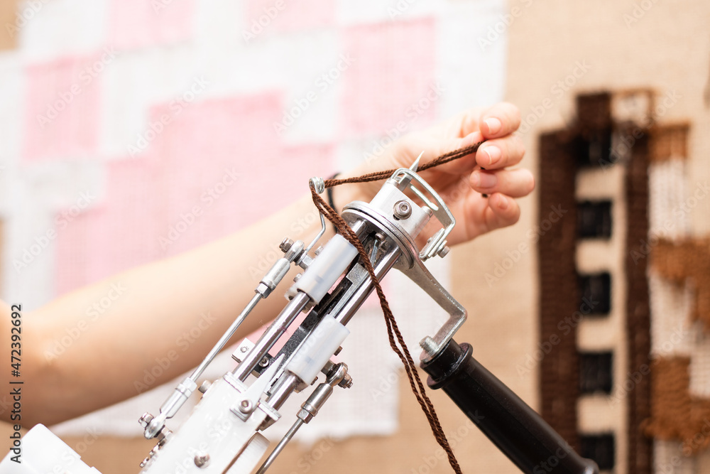Stockfoto Tufting process making a tufted rug using a tufting gun and