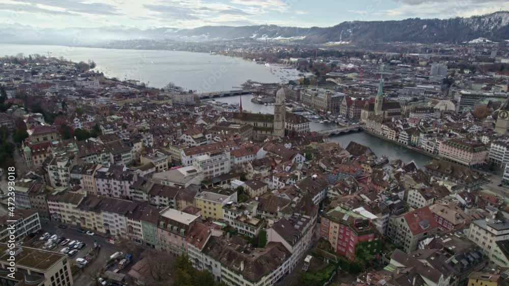 Aerial view of City of Zürich with lake Zürich and Swiss alps in the background on a cloudy winter day. Movie shot December 1st, 2021, Zurich, Switzerland. Aerial view of City of Zürich with lake Zürich and Swiss alps in the background on a cloudy winter day. Movie shot December 1st, 2021, Zurich, Switzerland.