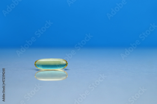 omega 3 capsule on mirror surface