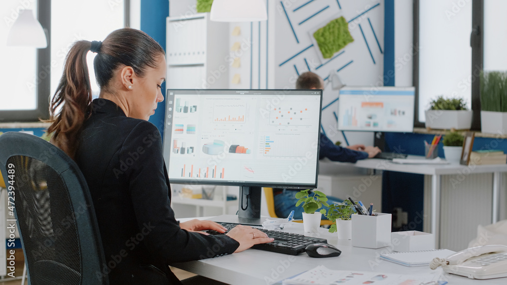 Engineer designing data charts on computer for business project. Woman with corporate job working with technology for management and marketing strategy. Entrepreneur planning analysis Engineer designing data charts on computer for business project. Woman with corporate job working with technology for management and marketing strategy. Entrepreneur planning analysis
