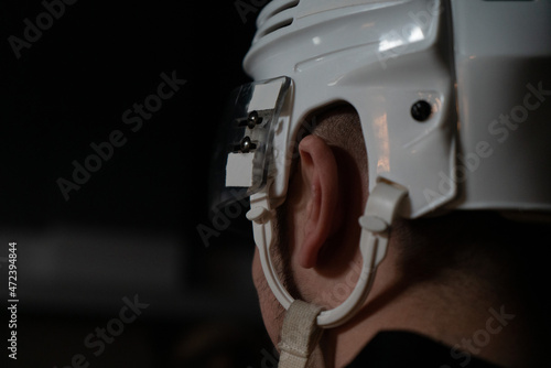 hockey player in white helmet close up