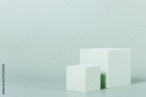 Abstract light green background with cubes podiums