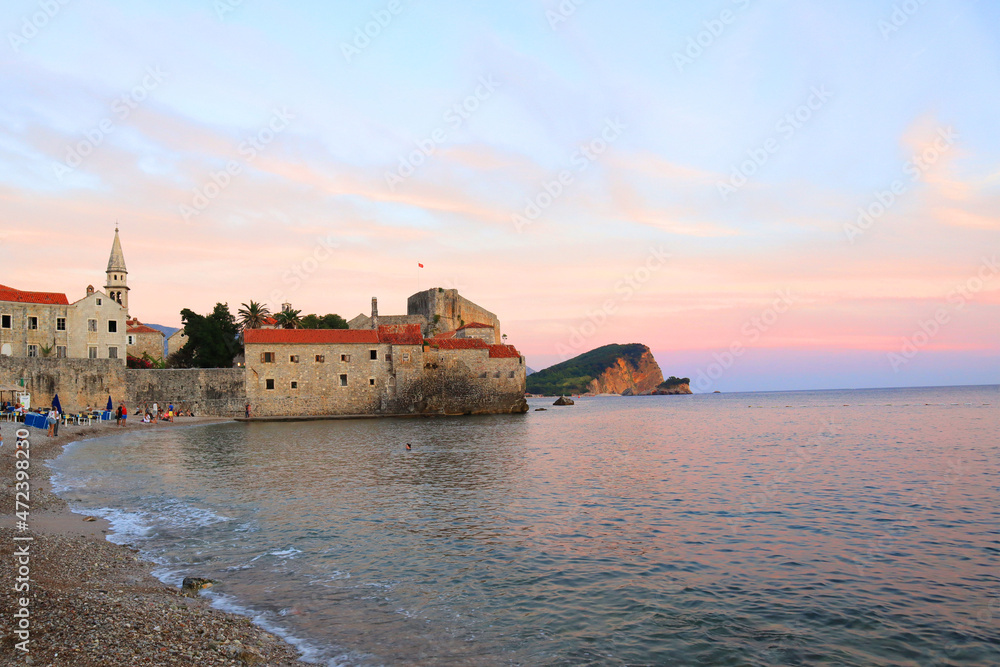  View of Budva Castle and old town beach at sunset in Montenegro