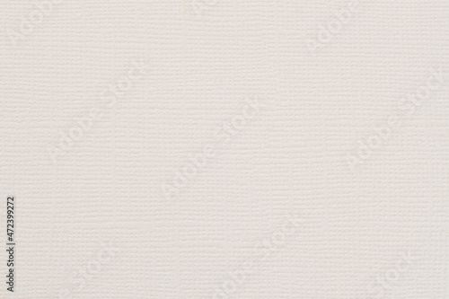 Close-up of canvas texture with delicate grid pattern, cream color