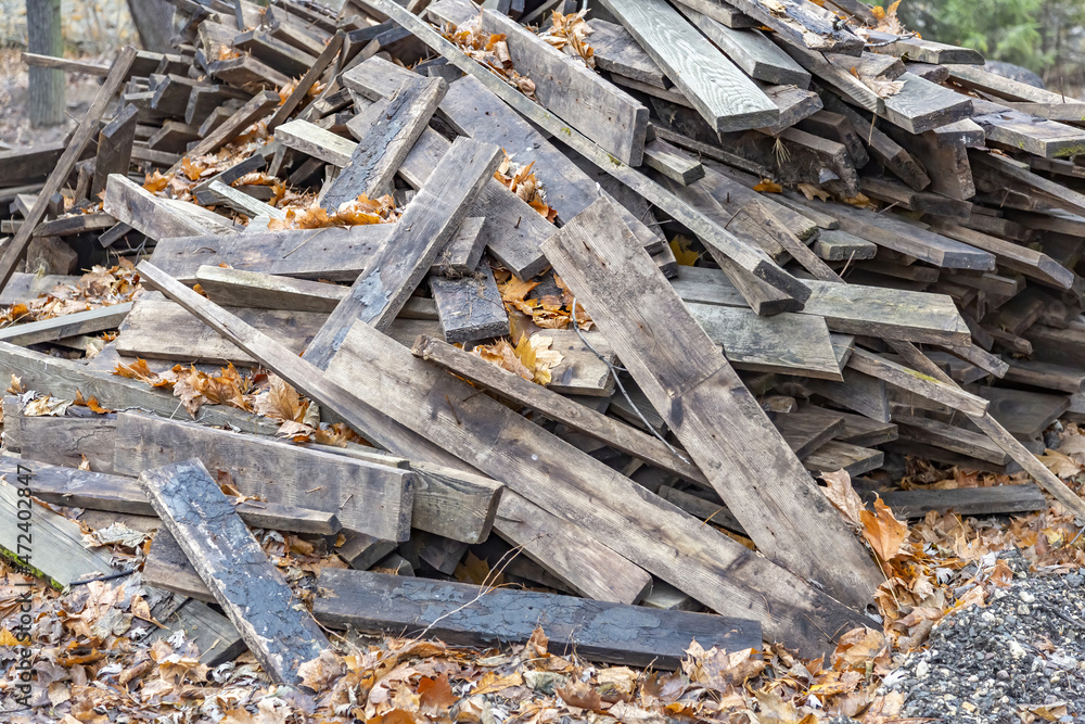 Heap of long wooden boards for the construction and improvement of the yard Heap of long wooden boards for the construction and improvement of the yard