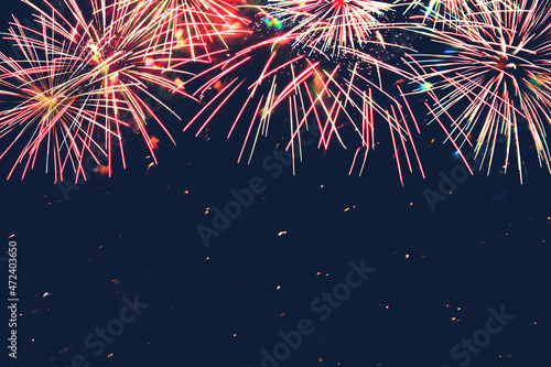 Сolorful Frame of fireworks on blue background.