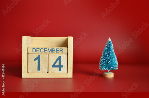 December 14, Calendar design with Christmas tree on red table background.