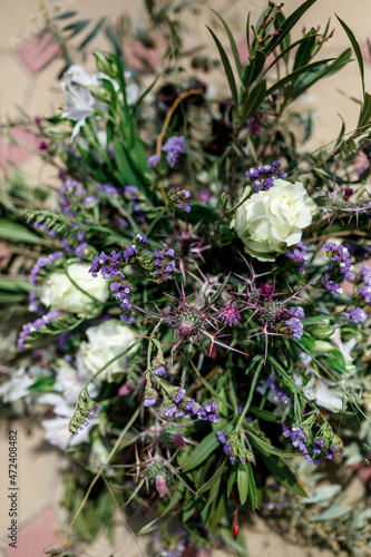 eryngium close-up against the background of the rest of the bouquet in blur