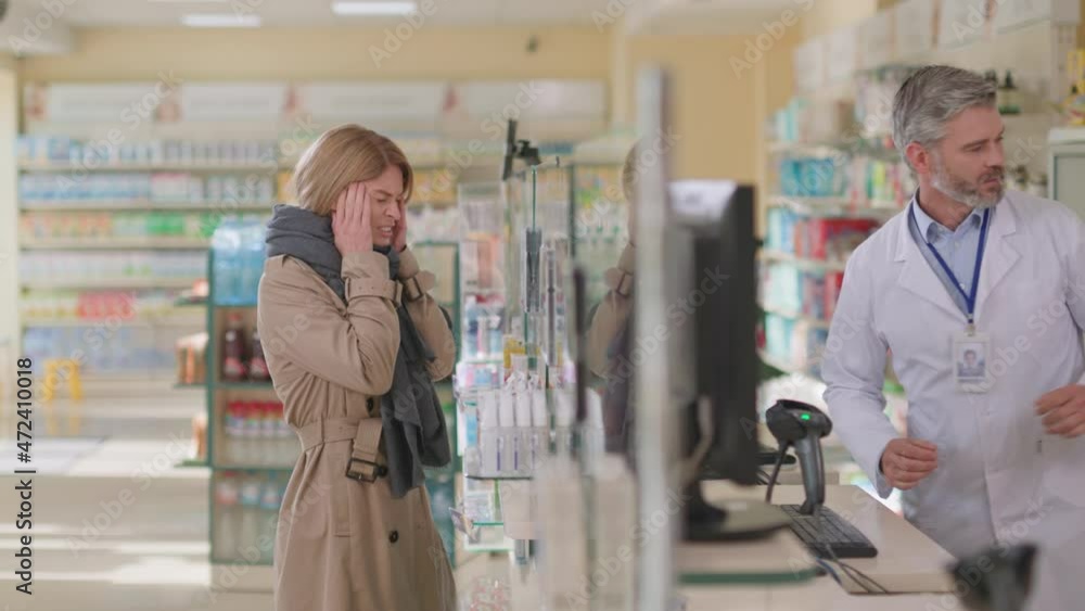 Sick young woman in drugstore asking for medication, consulting with professional male polite pharmacist. Medical consultation. Doctor visit. Pharmacy. Sick young woman in drugstore asking for medication, consulting with professional male polite pharmacist. Medical consultation. Doctor visit. Pharmacy.