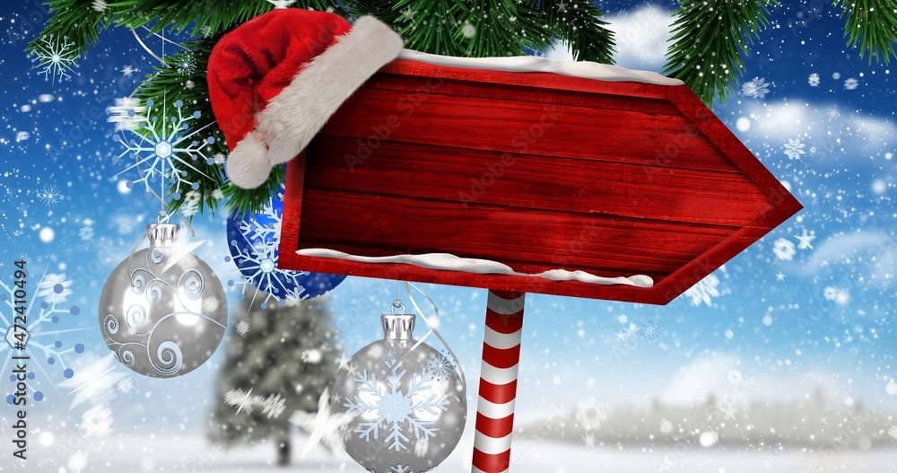Digital composite image of santa hat on blank red direction sign board ...