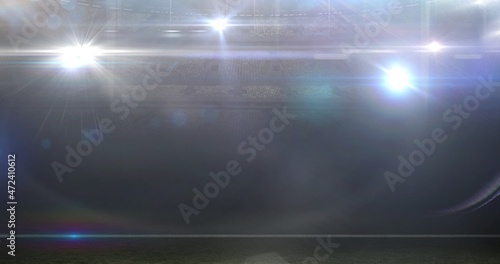 Digital composite image of illuminated american football stadium with glowing bright lights