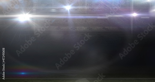 Lens flare at illuminated american football stadium at night © vectorfusionart
