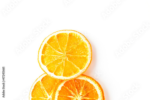 flat lay with ripe and dried round slices of orange isolated on white background. fruit chips. healthy sweets. soft focus