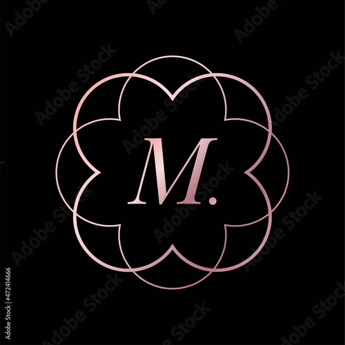 Golden luxury vector logo design in flower or mandala shape with letter M. Massage and spa logo.