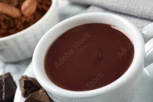 Yummy hot chocolate in cup on table, closeup