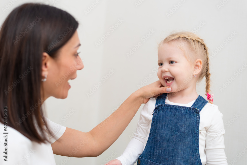 Woman speech therapist helps girls correct her speech Woman speech therapist helps girls correct her speech