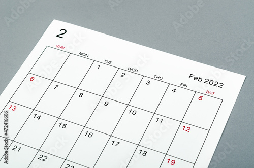 February 2022 calendar sheet on grey background.