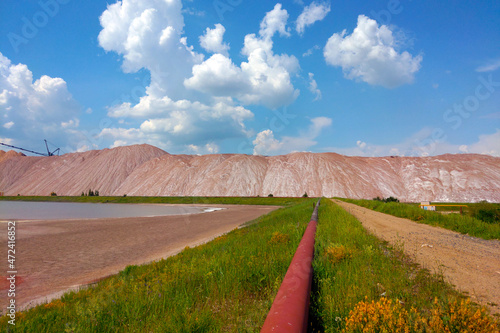 View of the production pipe against the background of spent ore for the extraction of salt and fertilizers. Minerals. photo