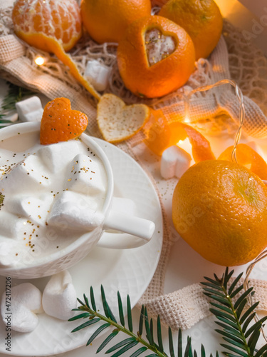 Tangerines and heart shaped marshmallow slices with latte coffee for romantic Christmas 