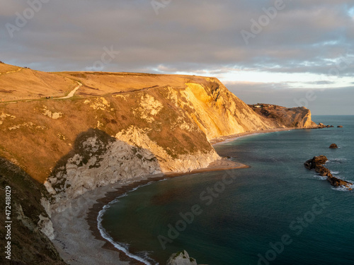 man o war cove Dorset England as the sun starts to go down on a bright winters day