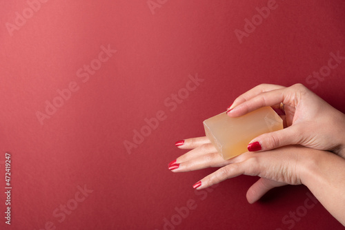 Female hands applying soap on fingers with copy space
