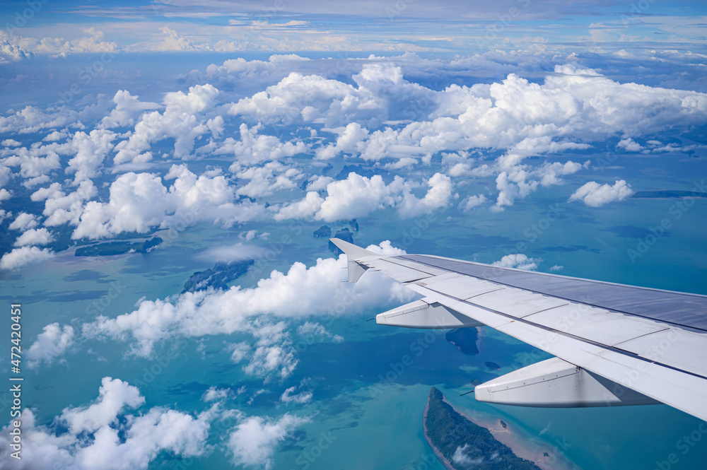 View of airplane wing with blue sky and cloud. View of airplane wing with blue sky and cloud.