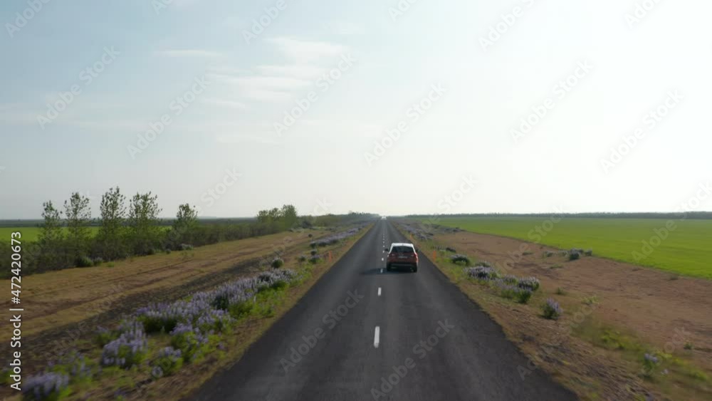 Birds eye tracking car driving on Ring road, most important highway in Iceland. Drone view showing amazing and breathtaking panorama of surreal icelandic countryside Birds eye tracking car driving on Ring road, most important highway in Iceland. Drone view showing amazing and breathtaking panorama of surreal icelandic countryside