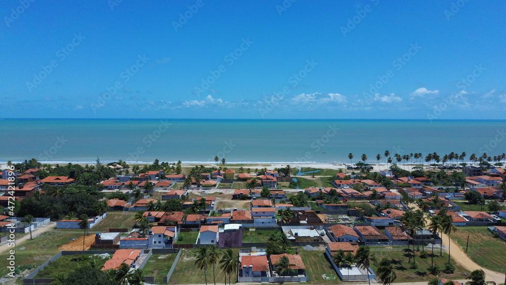 Sunny coastline, with blue sea, and a small village Sunny coastline, with blue sea, and a small village