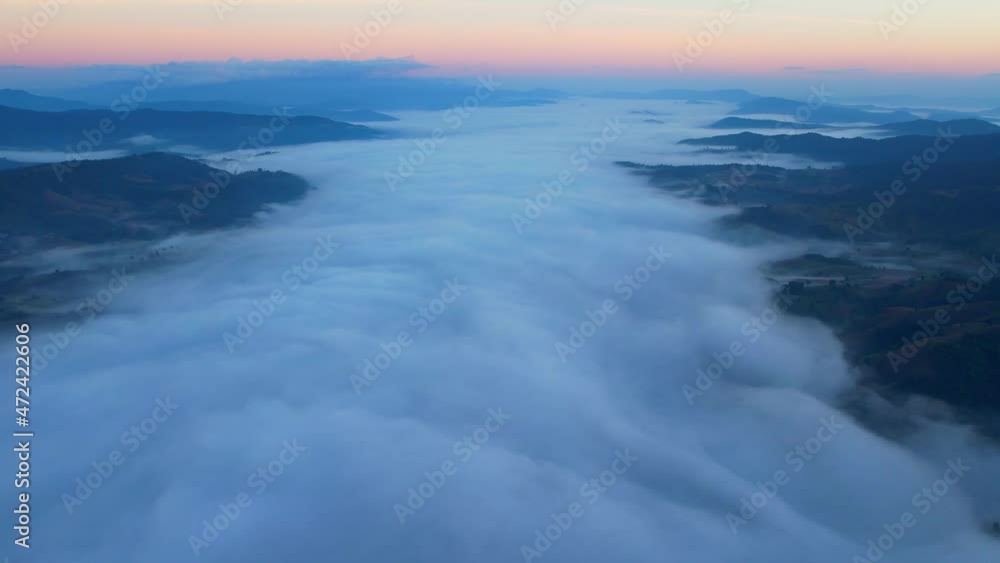 4K Drone Flying through the clouds at dusk or dawn. Aerial top cloudscape view from drone. Tropical forest with smoke and fog.
4K Drone Flying through the clouds at dusk or dawn. Aerial top cloudscape view from drone. Tropical forest with smoke and fog.